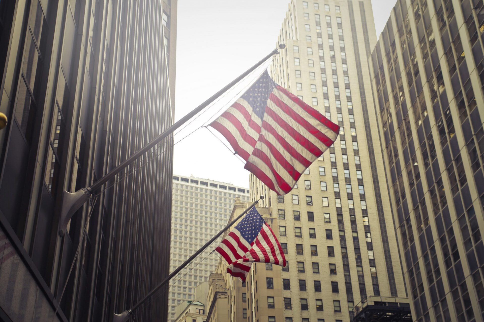 shot-two-american-us-flags-high-rise-building_181624-3168 Licensed Electrician and Electrical Contractor in West Palm Beach, Florida|Flagpole Installation and Repair